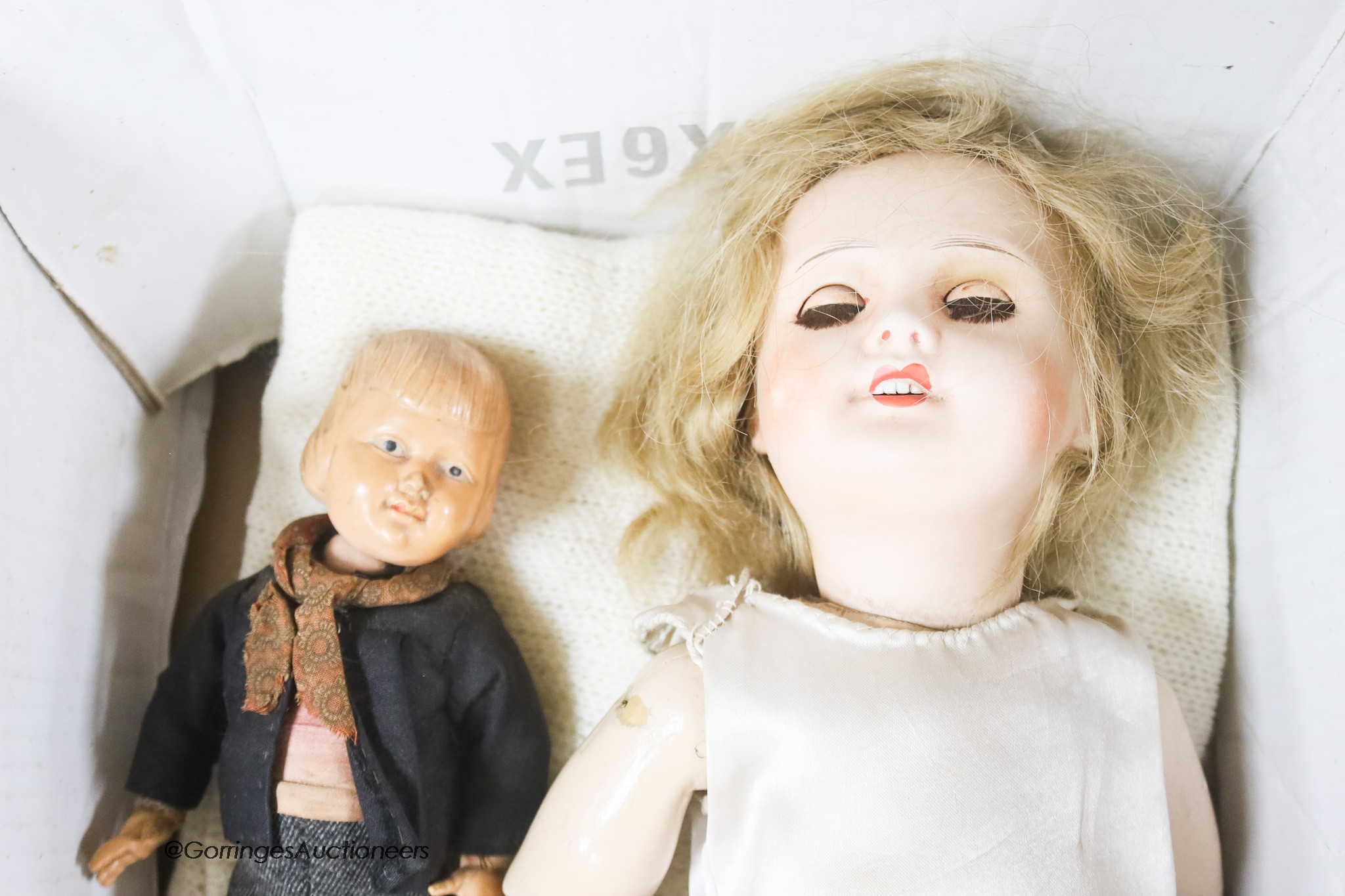 A bisque headed doll, believed by family repute to have been Princess Beatrice's and two celluloid dolls